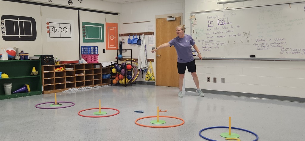 Teacher pointing to horseshoe stakes