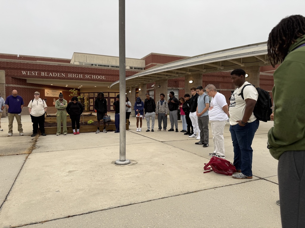 Students stand in a large circle around a flagpole outside West Bladen High School during See You at the Pole