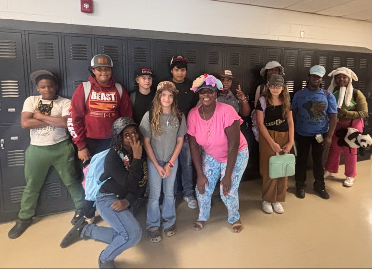 students and teacher in the hallway in front of lockers