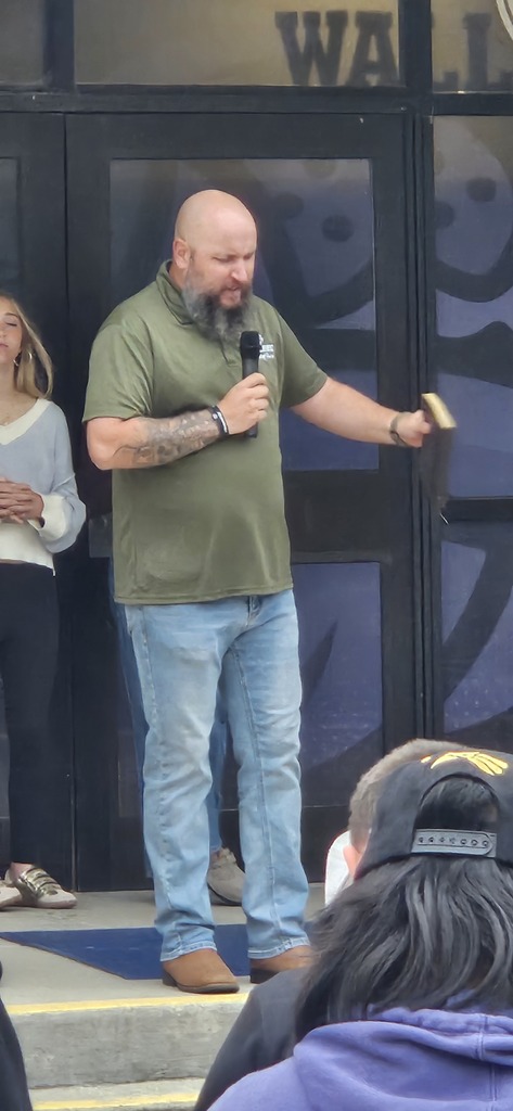 Youth Pastor praying for students