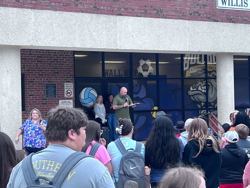 Students praying around the flag pole