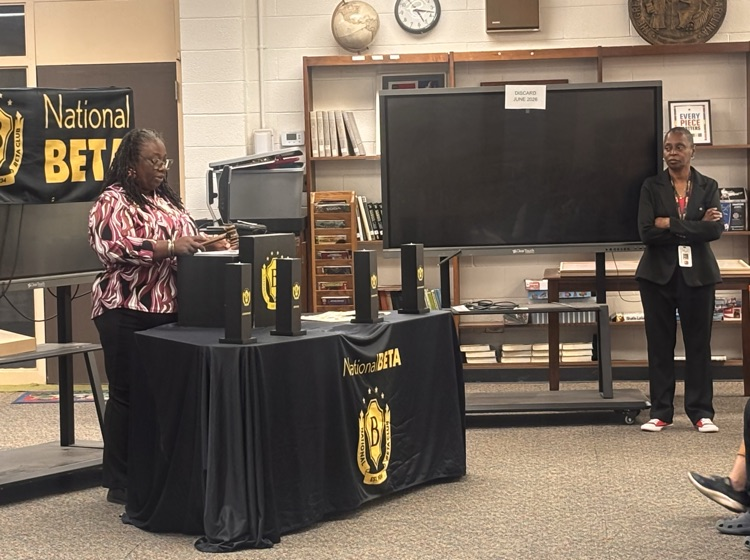Beta sponsor speaking behind podium at ceremony 