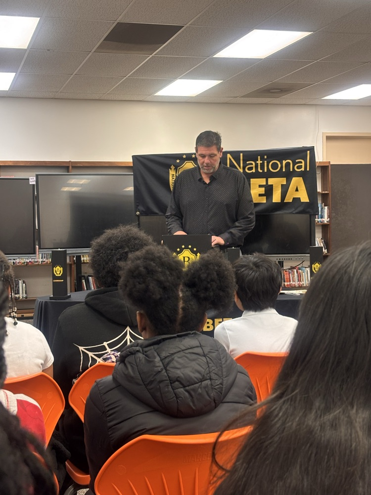principal speaking behind podium at ceremony 