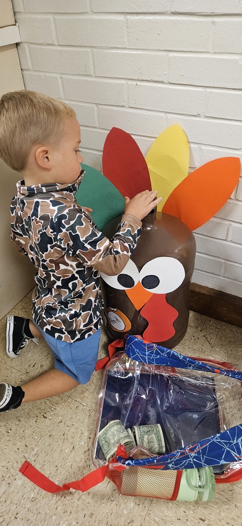 Student stuffing turkey jugs with money