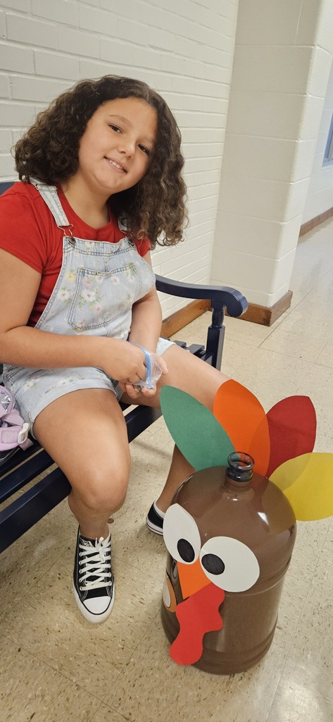 Student stuffing turkey jugs with money