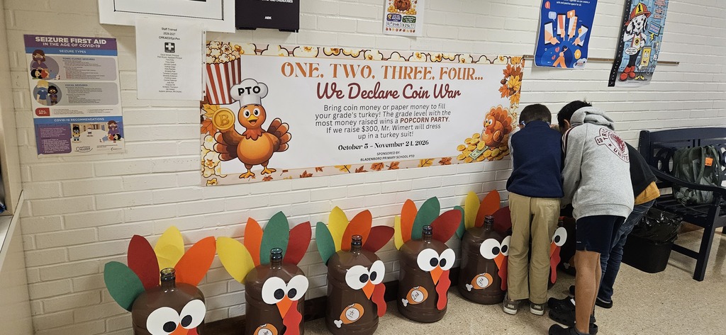 Students stuffing turkey jugs with money