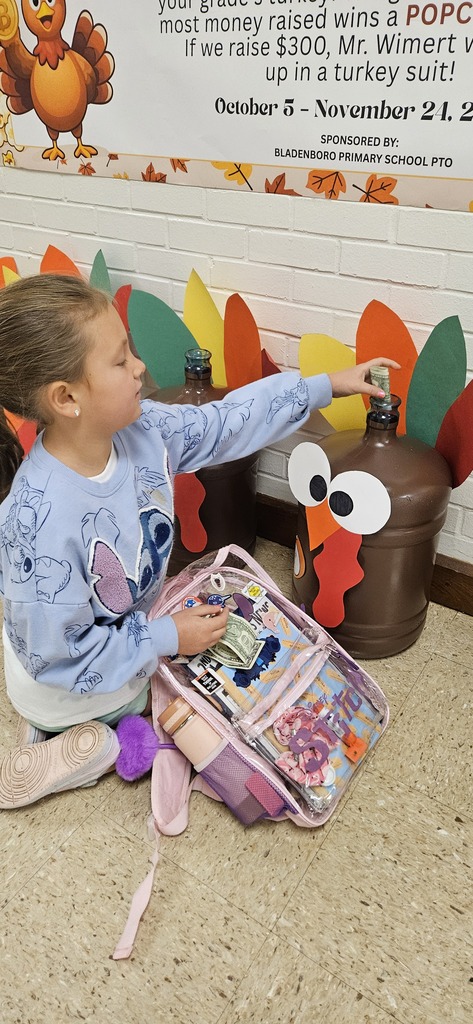 Student stuffing turkey jugs with money