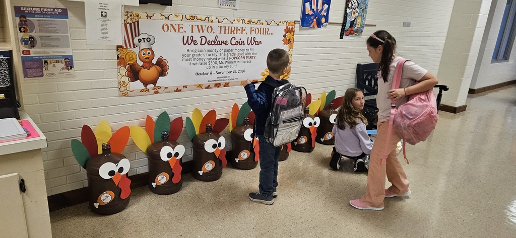 Students stuffing turkey jugs with money