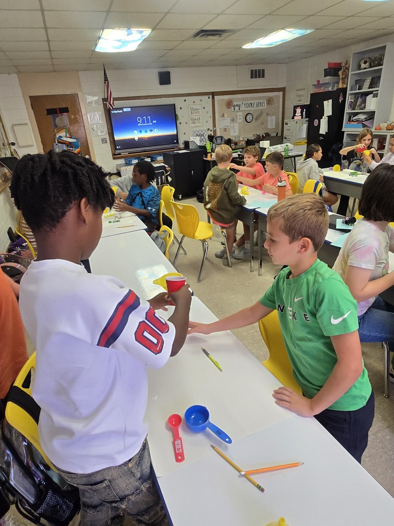 Bladenboro Middle School fifth graders work collaboratively in small groups during a hands-on chemical reaction lab. Students measure and prepare materials, make observations, and explore changes in matter while developing scientific inquiry and teamwork skills.
