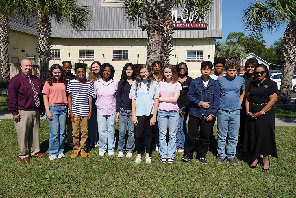 A group of middle and high school students stand outside San Jose smiling with the Superintendent and Deputy Superintendent.