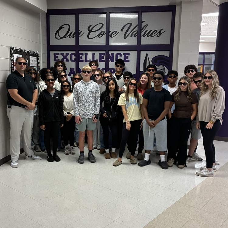 principal & students posing while wearing sunglasses