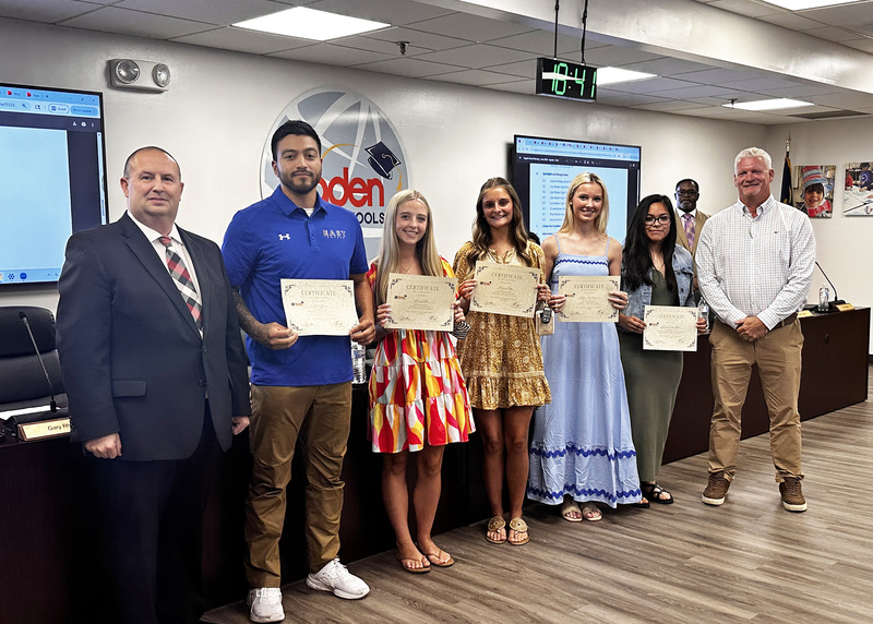 Members of the East Bladen High School Girls Soccer Team stand with their assistant coach, superintendent, and board chair to be recognized for their success.