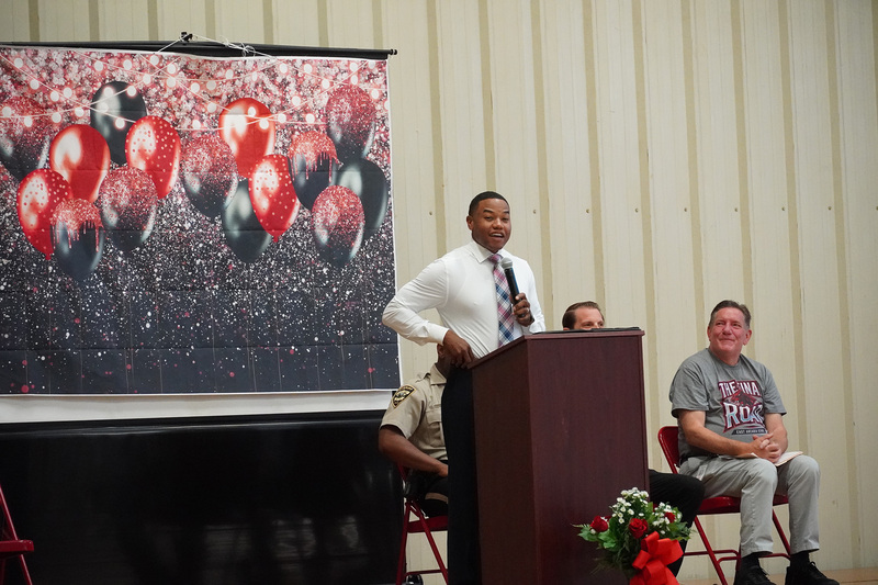 A speaker stands on stage at a podium.