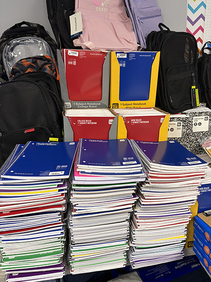 Stocks of spiral bound notebooks, and mesh bookbags.