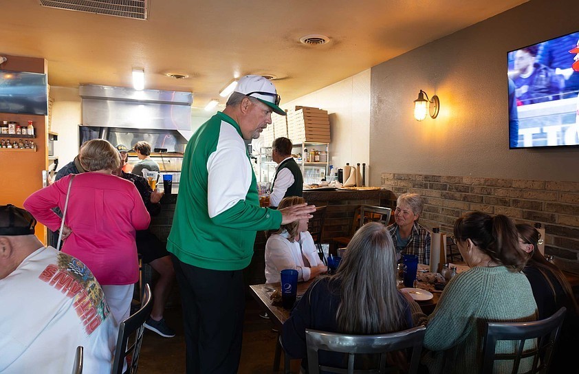 Sophie Ayers/ News Tribune photo: Mark McCarter, center, speaks to supporters at his school board election watch party on Tuesday, April 7, 2026, at Pizza Haus. McCarter was running for Blair Oaks School Board.