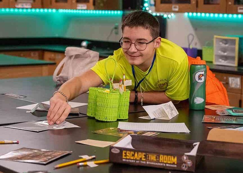 Julie Smith/News Tribune Landyn Groll stays at the escape room table during break to continue finding ways out while taking part in Friday's Gifted Students Conference at Southern Boone County Middle School. Groll is in the eighth grade at Blair Oaks Middle School.
