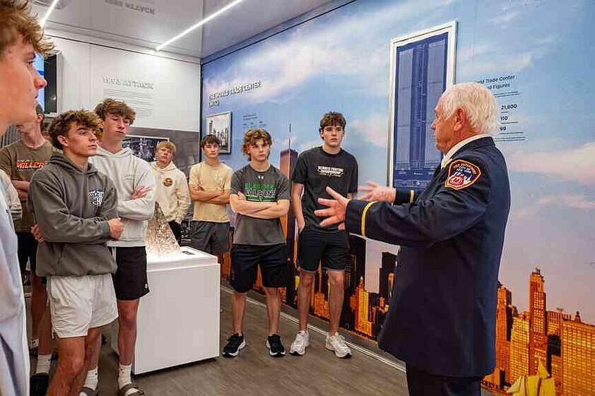 Julie Smith/News Tribune Herb Penner talks to Blair Oaks High School students as they tour the 9/11 Never Forget Mobile Exhibit on Thursday morning as the traveling museum was parked on the south drive of the Missouri Capitol. Penner is a retired battalion chief for New York City Fire Department who responded to the World Trade Centers on Sept. 11, 2001.