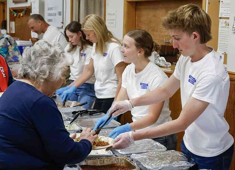 Abram Barker/News Tribune photo: Blair Oaks student Levi Mengwasser serves Rosemary Bardwell baked beans during an Operation Bugle Boy event on Sunday, March 29, 2026, at VFW Post 1003 in St. Martins, Mo. "I love coming here and serving, I love seeing all the delight on peoples' faces," Mengwasser said. "I'm wanting to go into the military myself, so this is a good way to give back and learn about what I might have to face one day."