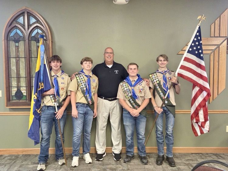 Supt. Todd Strom with the four Eagle Scout recipients