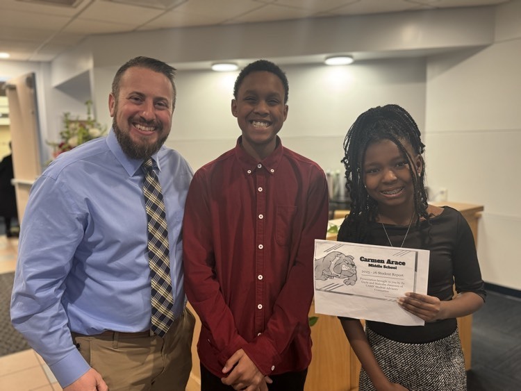 Two students and one adult posing fir a photo