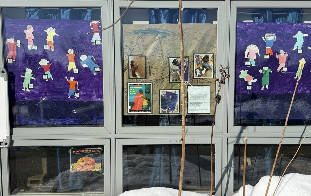 Preschool Window Decoration of people made out of paper.