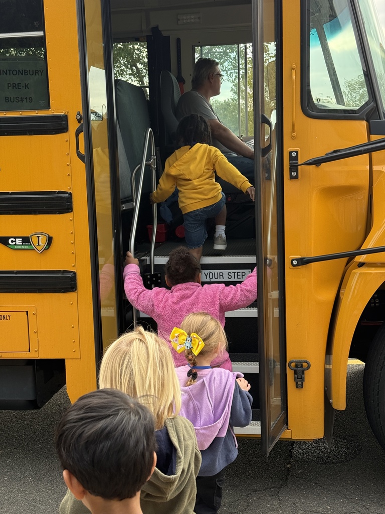 Young children boarding a bus.