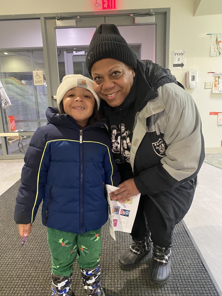 Mother and son smiling at the camera in winter gear.