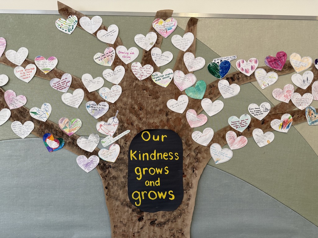 Tree on a bulleting board with hearts as leaves.