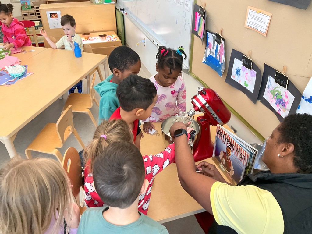 Five children standing around a stand mixer with a teacher making ice cream.