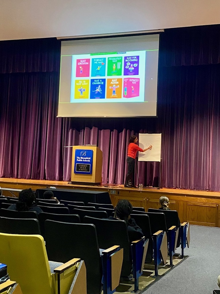 Author presenting on the stage in the auditorium