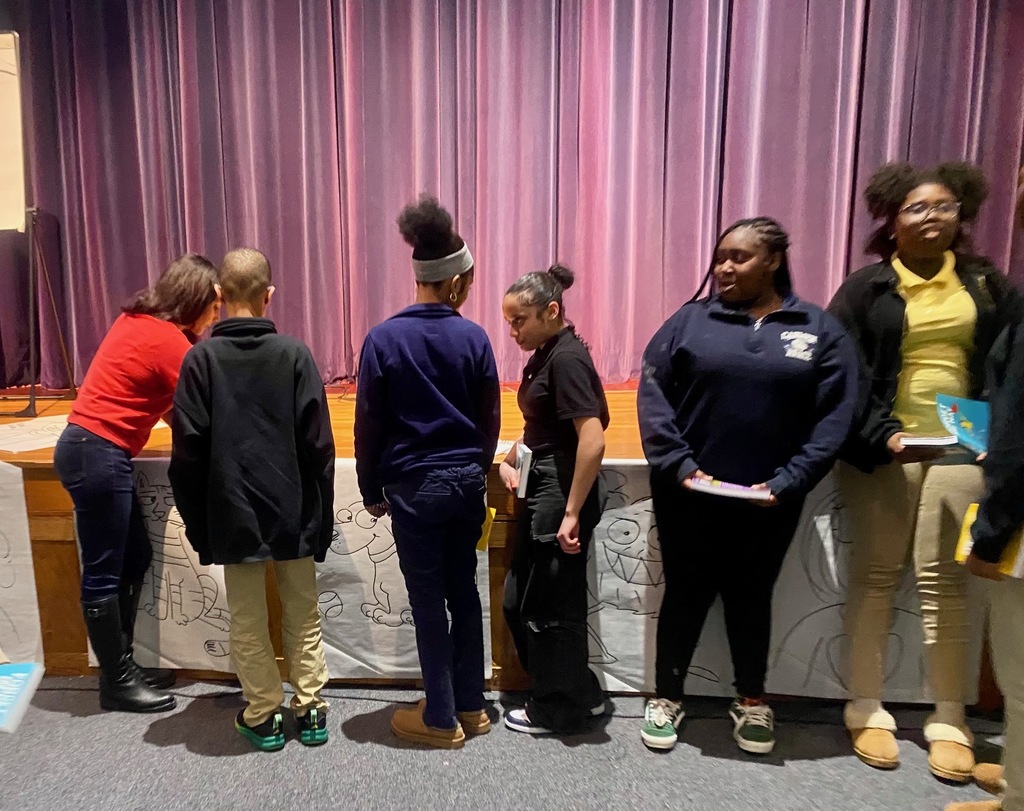 Students getting their books signed by the author