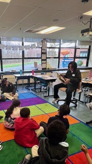 High school student reading to children