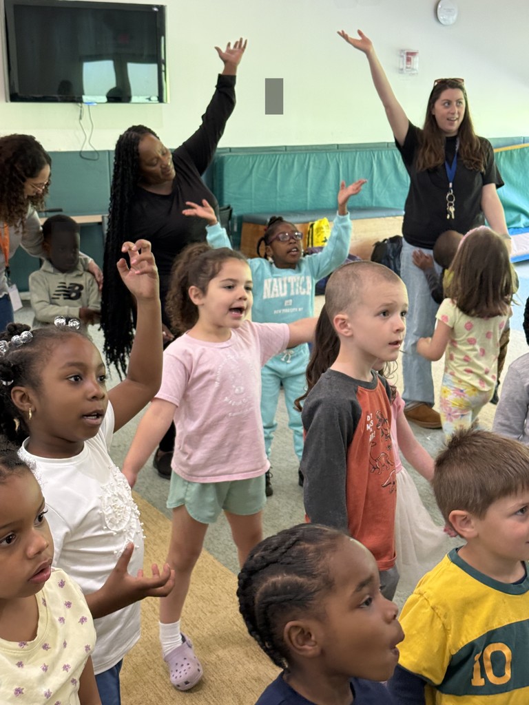 Group of young students and adults dancing.