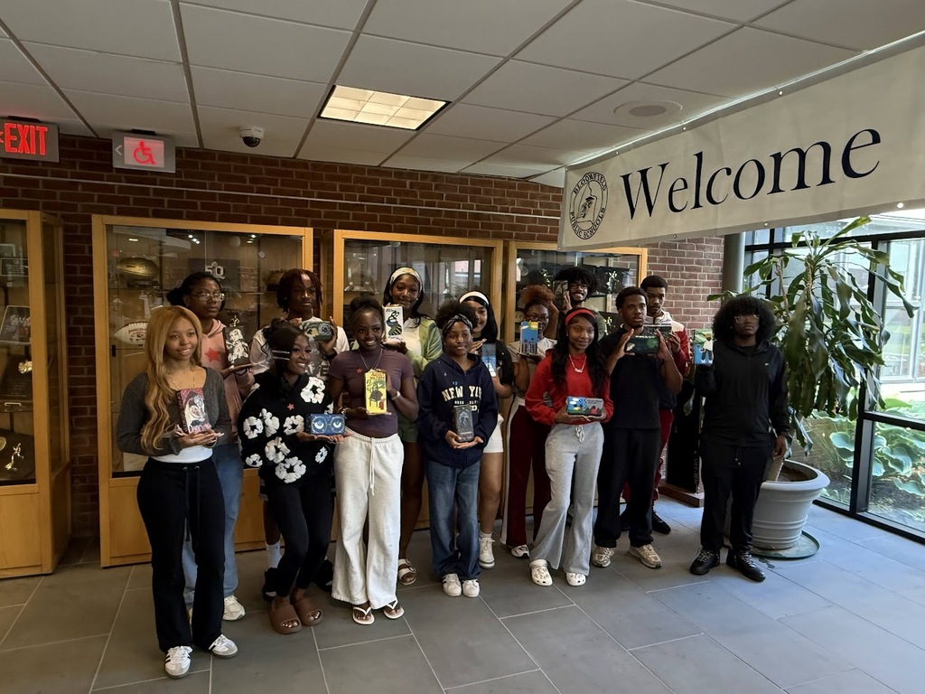 Student group posing with bricks