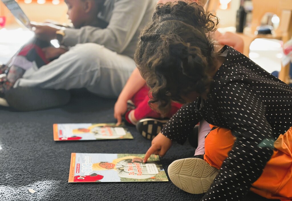 Preschool students read a My Big World magazine about pumpkins