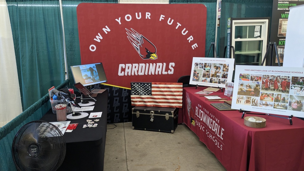 Bloomingdale Schools tables at the fair, with Cardinals backdrop.