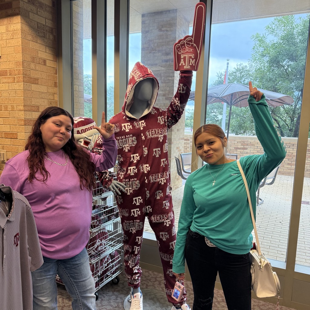 Students posing with the mannequin