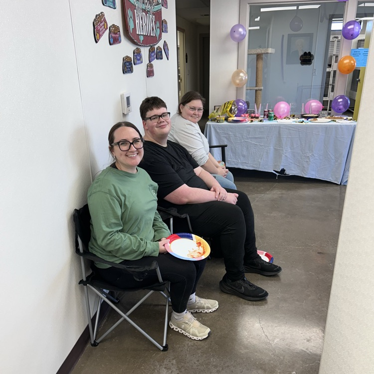 staff and students sit with party decor