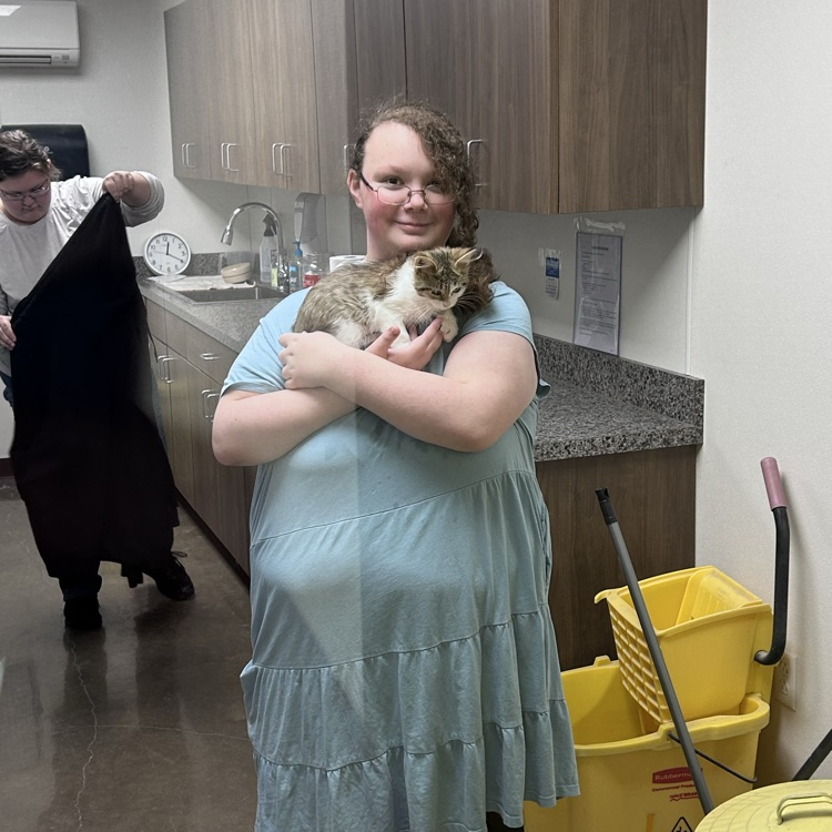 students posing with cats