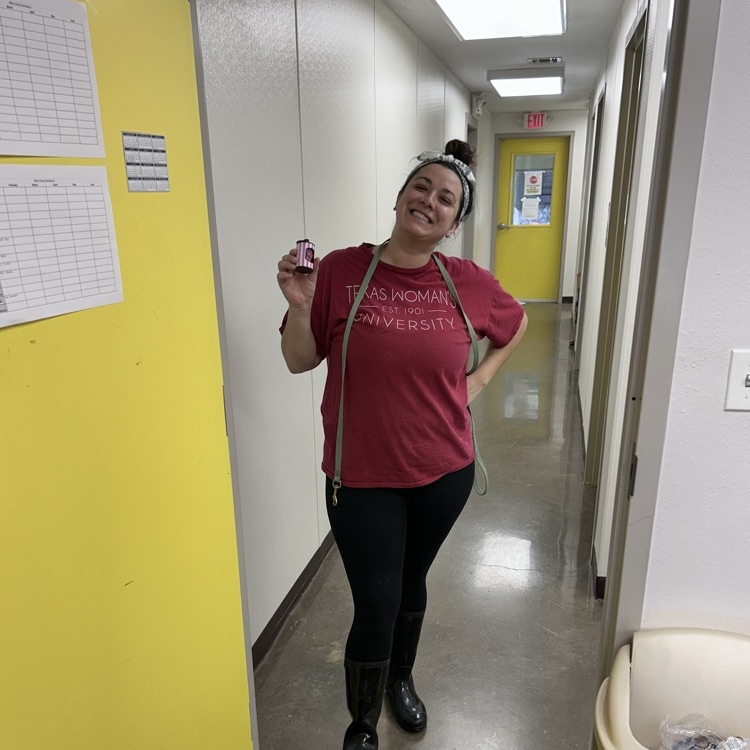 volunteer posing with poop bags