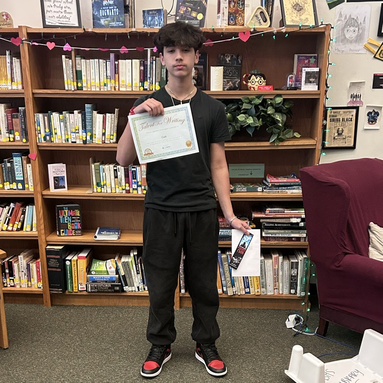 student poses with prize