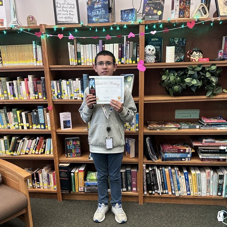 student poses with prize