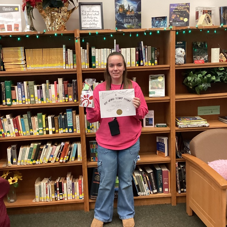 student poses with prize