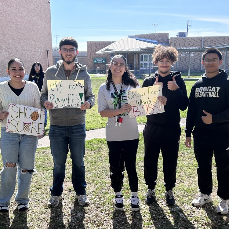 students pose with sign