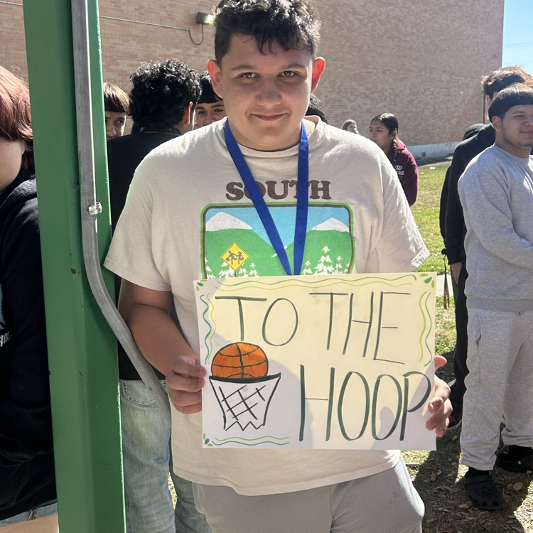 student pose with sign