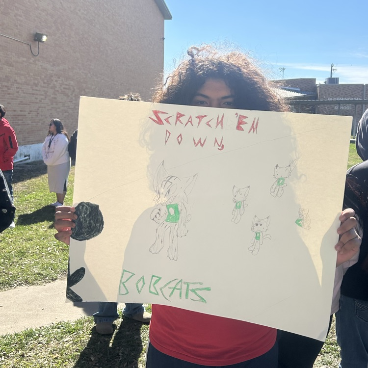 students pose with sign