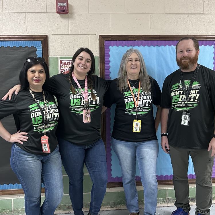 4 teachers pose in matching black tshirts