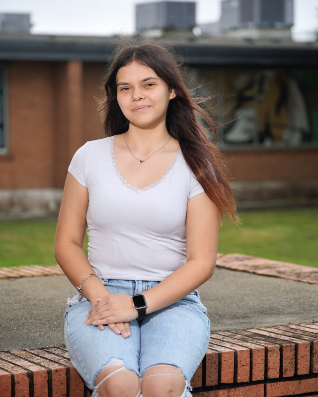 Senior poses outside