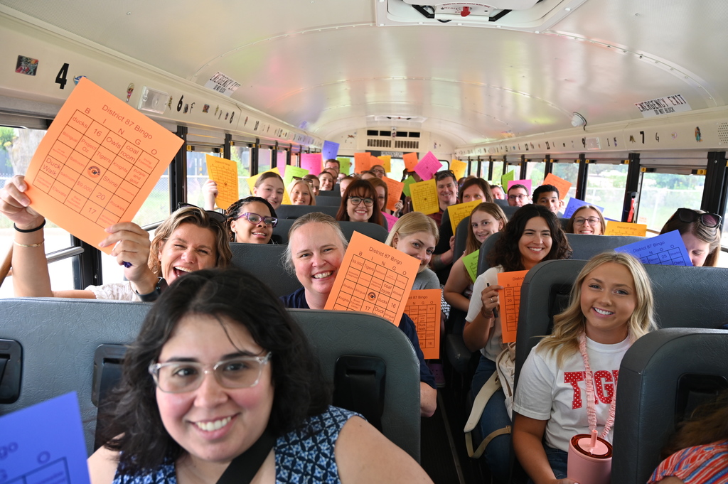 New teachers on bus holding Bingo cards
