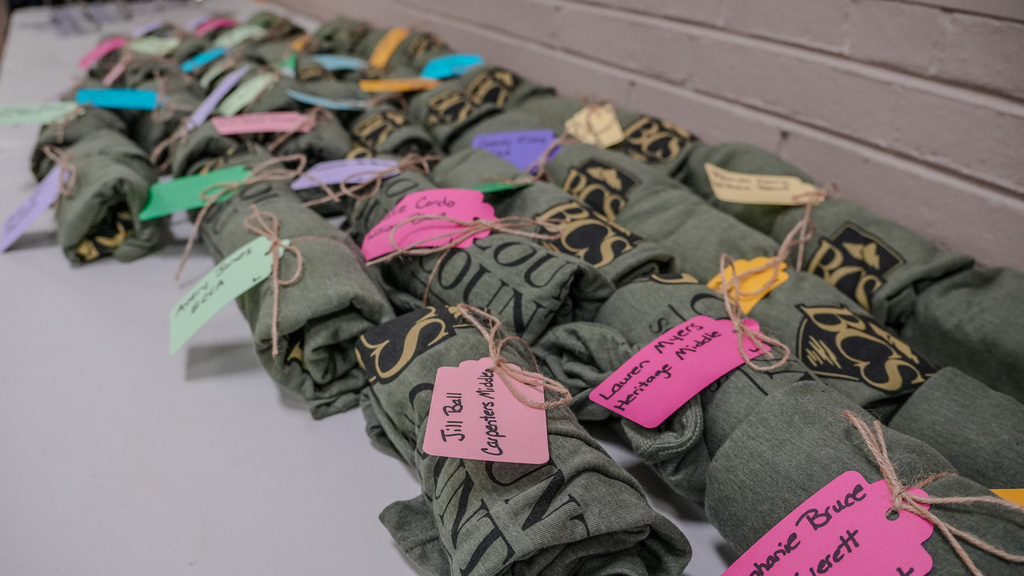 rolled up t shirts with name tags